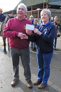 Presentation of cheque by Lion President Geoff Long to Anna Kerr
