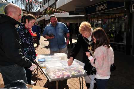The Mayor purchasing cakes from a stall