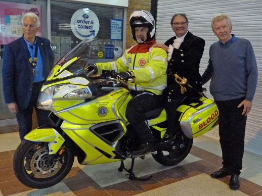 Blood-runner motorbike presented by Lion President Chris Muschamp, Jonathan Lucas, High Sheriff, West Sussex and Alan Shaw of Harbeth Audio